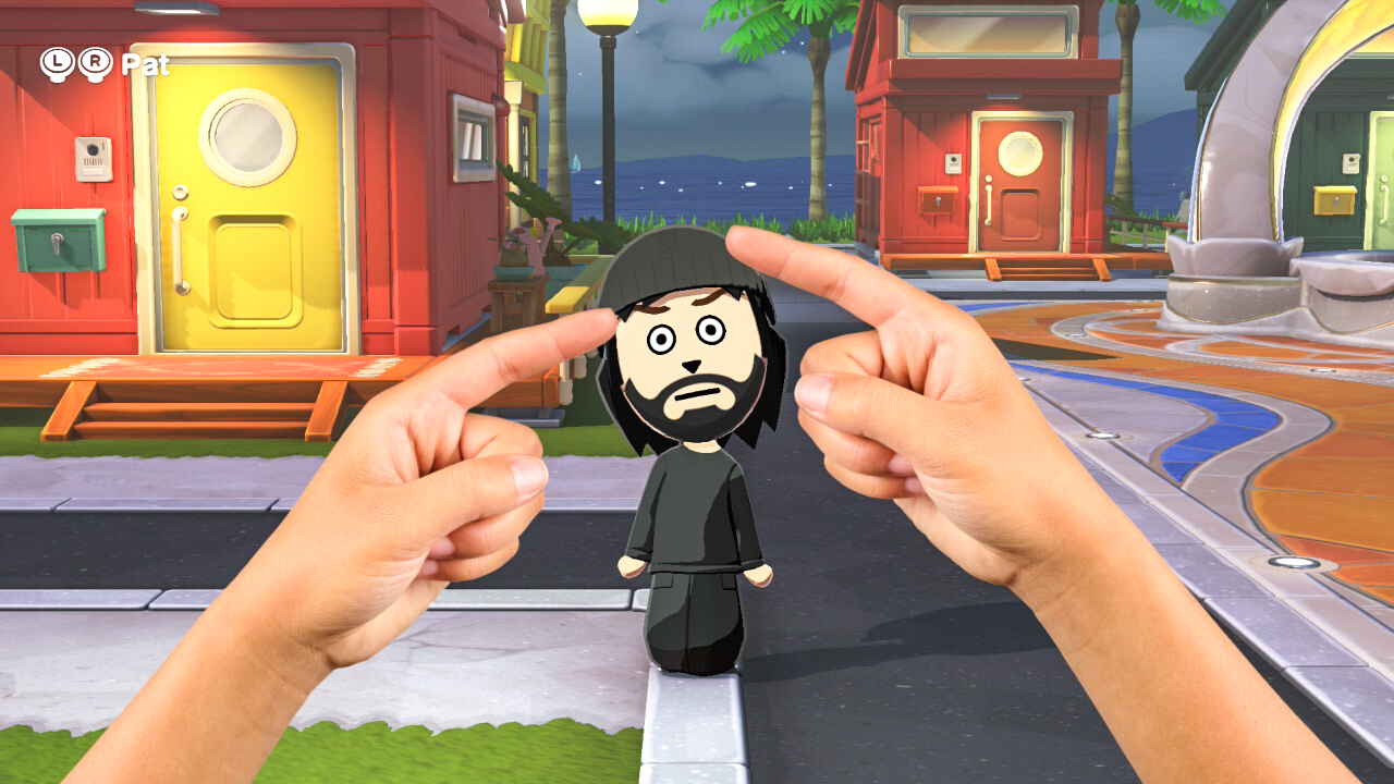 A screenshot showing two hands poking a Mii in Tomodachi Life: Living the Dream