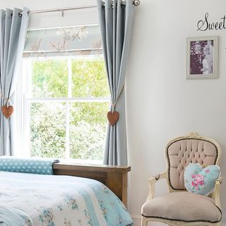 bedroom with armchair and floral bedding