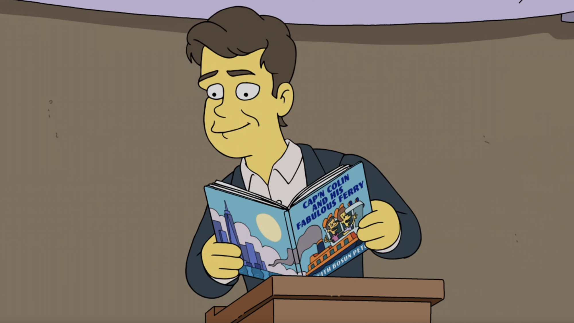 Animated Colin Jost standing behind a podium reading from the fake book Cap'n Colin And His Fabulous Ferry in The Simpsons Season 38 premiere.