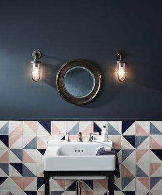 patterned blue and pink tiles in dark blue bathroom