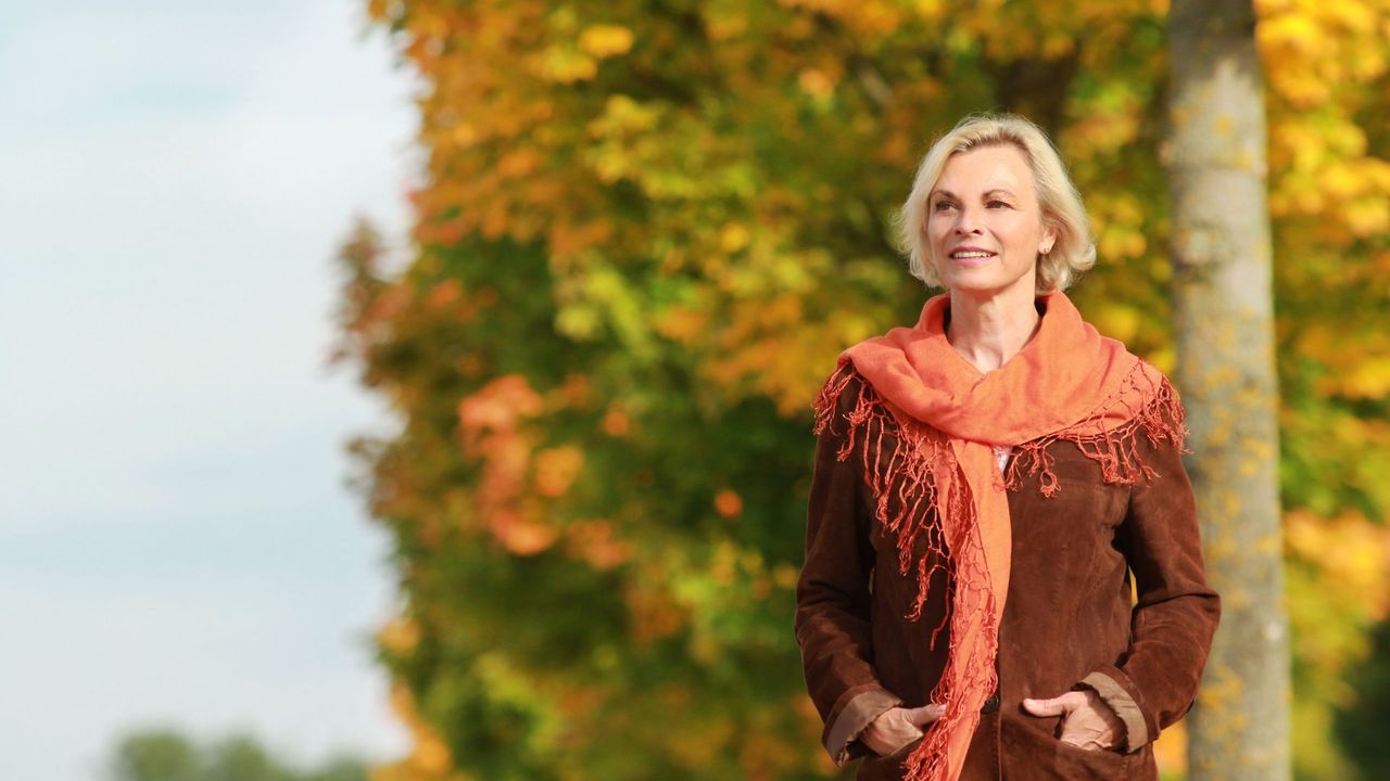 Woman walking through trees