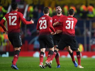 Marouane Fellaini of Manchester United (2R) celebrates after scoring his team's first goal with team mates during the UEFA Champions League Group H match between Manchester United and BSC Young Boys at Old Trafford