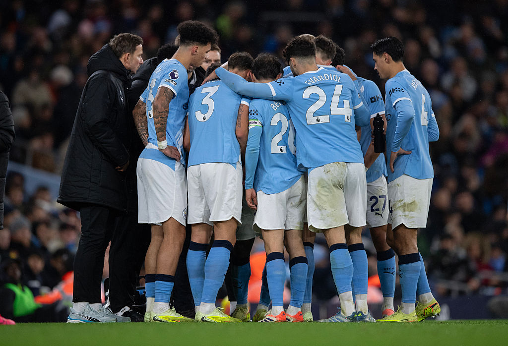 Pep Guardiola holds a mid-match team talk with his players