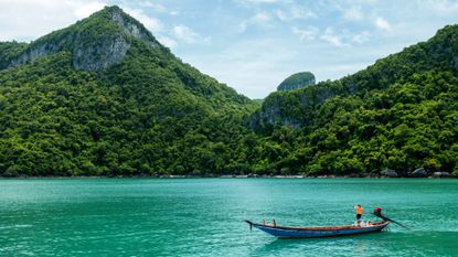 A person on a boat in the sea by Koh Samui