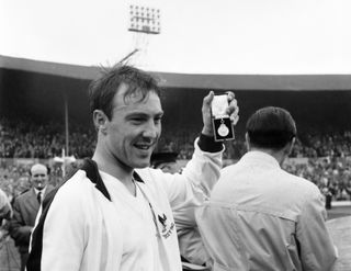 Jimmy Greaves holds up his winner's medal after Tottenham's victory over Burnley in the 1962 FA Cup final