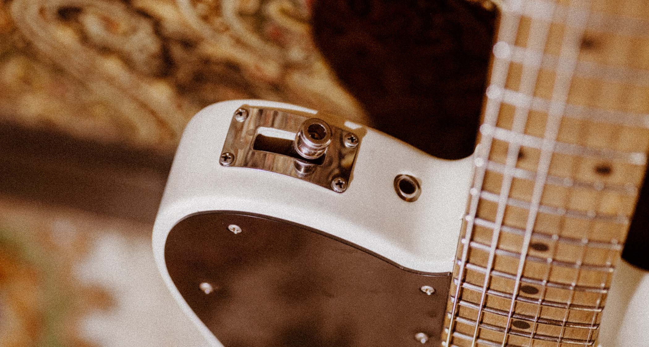 The Fender John Osborne Telecaster comes factory modded with a B-Bender and has an extended black pickguard on a Road Worn Olympic White body.