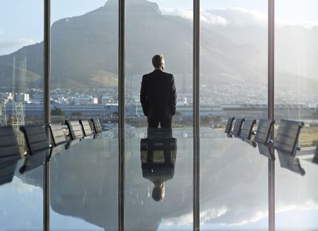 CEO in office, looking out of window