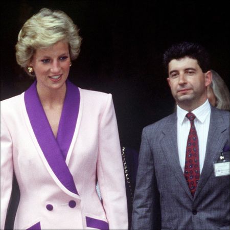 Princess Diana in Budapest, Hungary wearing a pink coat dress with purple accents, and her Private Secretary Patrick Jephson walking behind her 