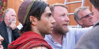 Guy Ritchie directs Mena Massoud on the set of Aladdin