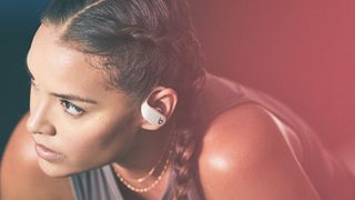 Woman wearing Powerbeats headphones, one of the best Apple headphones