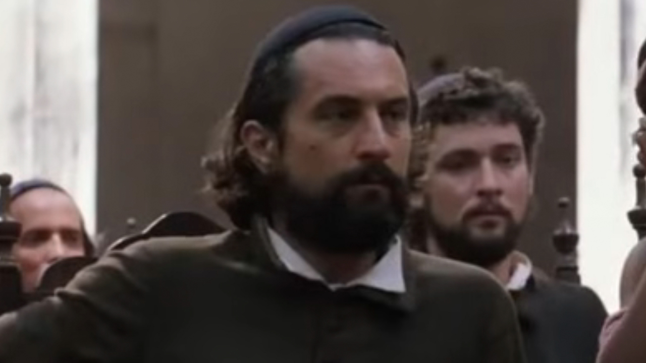 Robert De Niro with a beard and long hair in The Mission