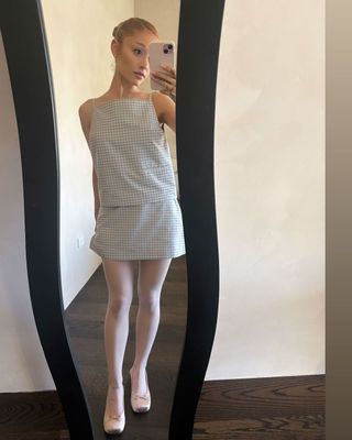 ariana grande wears a gingham skirt set and pink satin pointe ballet flats from sandy liang's spring/summer 2025 collection