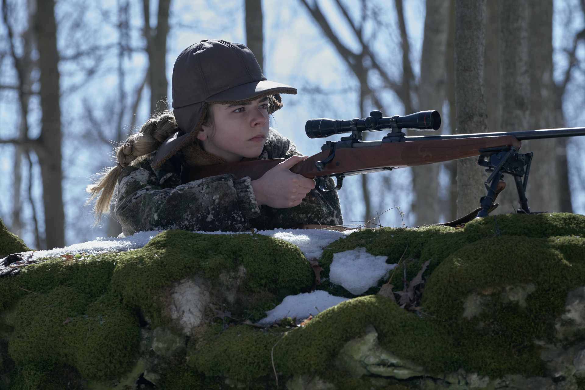 Matilda Lawler as young Kirsten, aiming a gun at Station Eleven