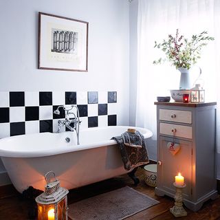 bathroom with chequered wall tiles and wooden flooring