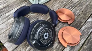 Dyson OnTrac wireless headphones on wooden table with earcaps removed