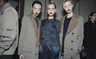 Models wearing grey coats and patterned clothing