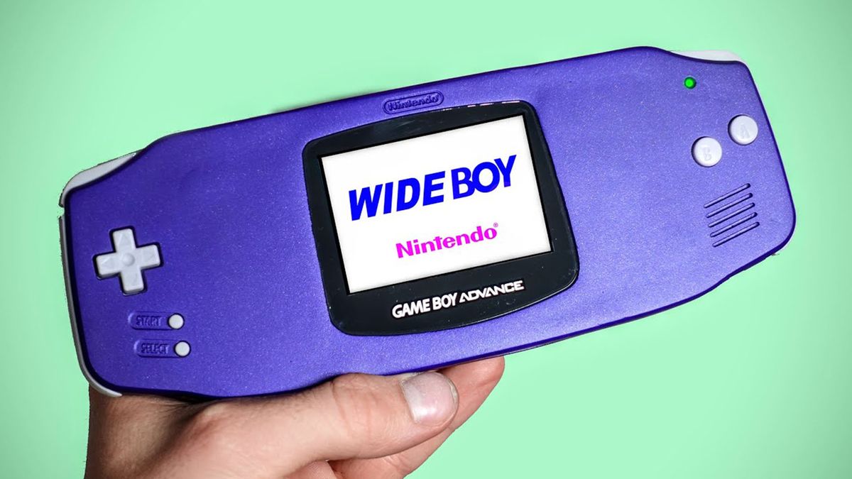 A Modded version of the gameboy advance held in a hand on a mint green background