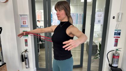 Woman performing resistance band arm workout