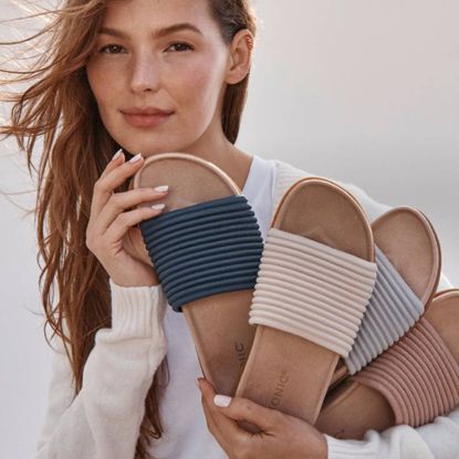 Woman holding Vionic sandals
