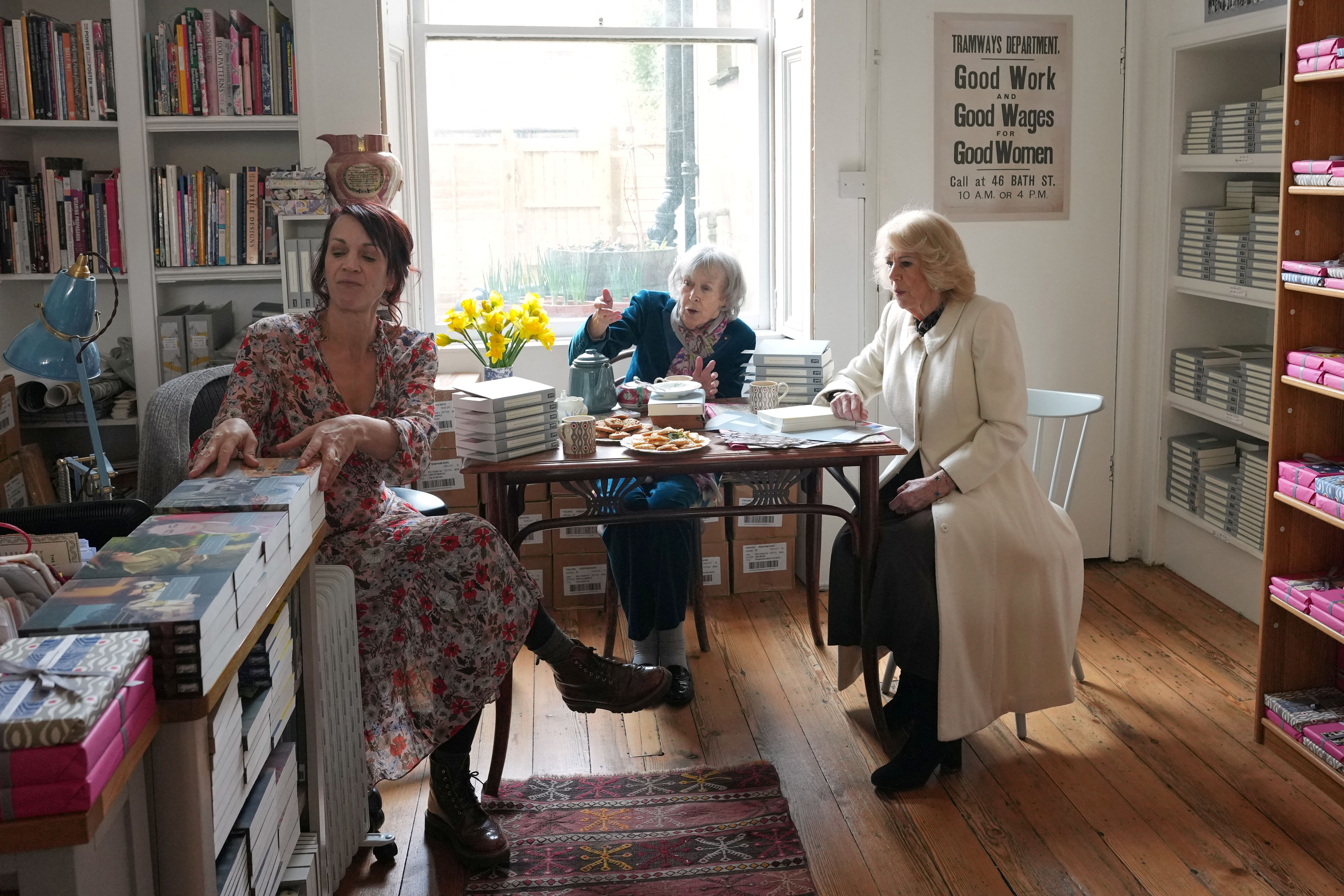 Britain's Queen Camilla (R) talks to Francesca Beauman (L) and Nicola Beauman (C) as she visits Persephone Books, an independent publisher and bookshop, in the city of Bath, south-west England on February 17, 2026. (Photo by Alastair Grant / POOL / AFP)