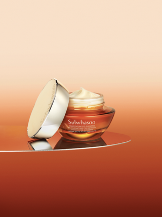 a bottle of sulwhasoo cream in front of a backdrop