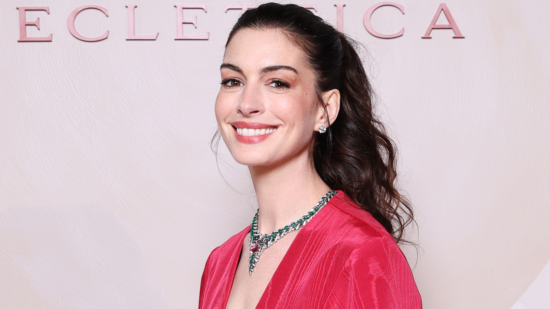 Anne Hathaway attended a Bulgari event in Milan dressed in a red ballgown and Bulgari jewelry