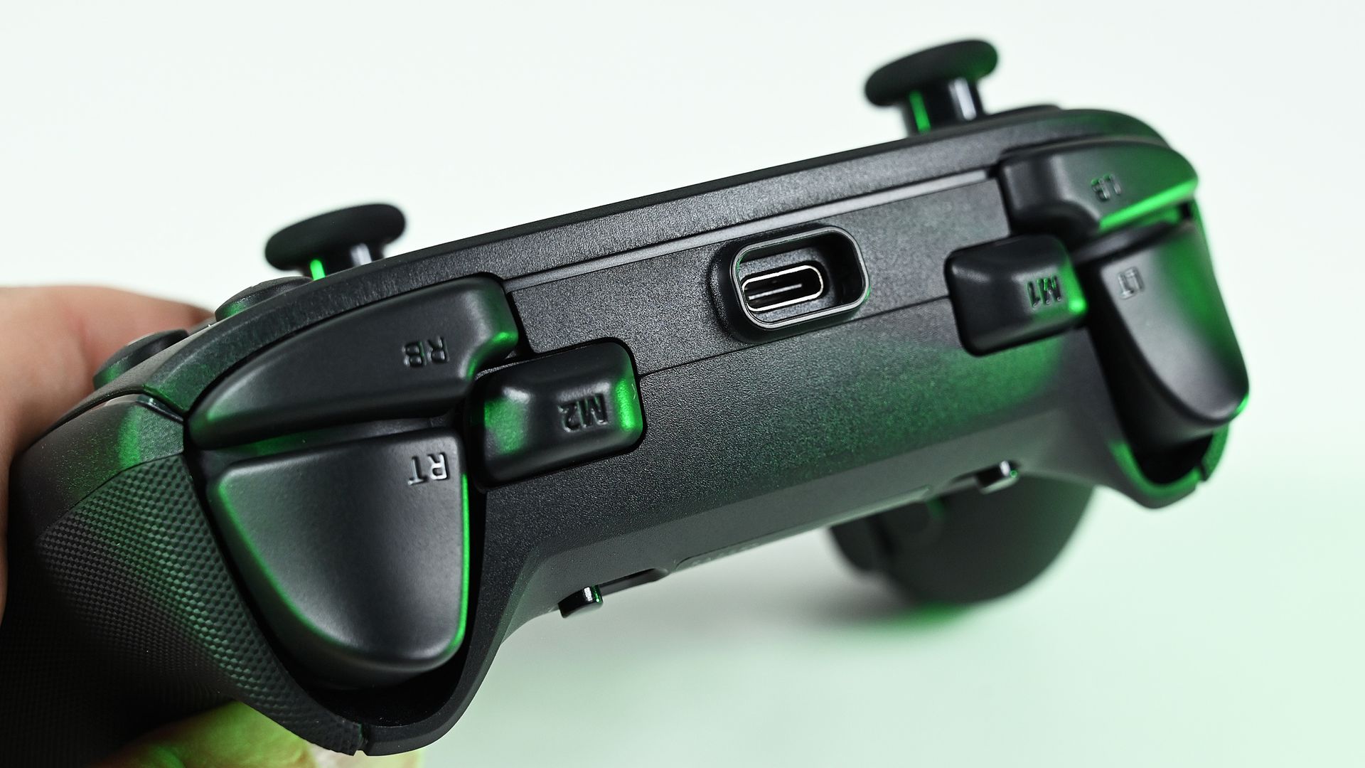 Close-up of the controller's top edge, highlighting the recessed USB-C connection port, bumper buttons, and remappable M1 and M2 buttons.