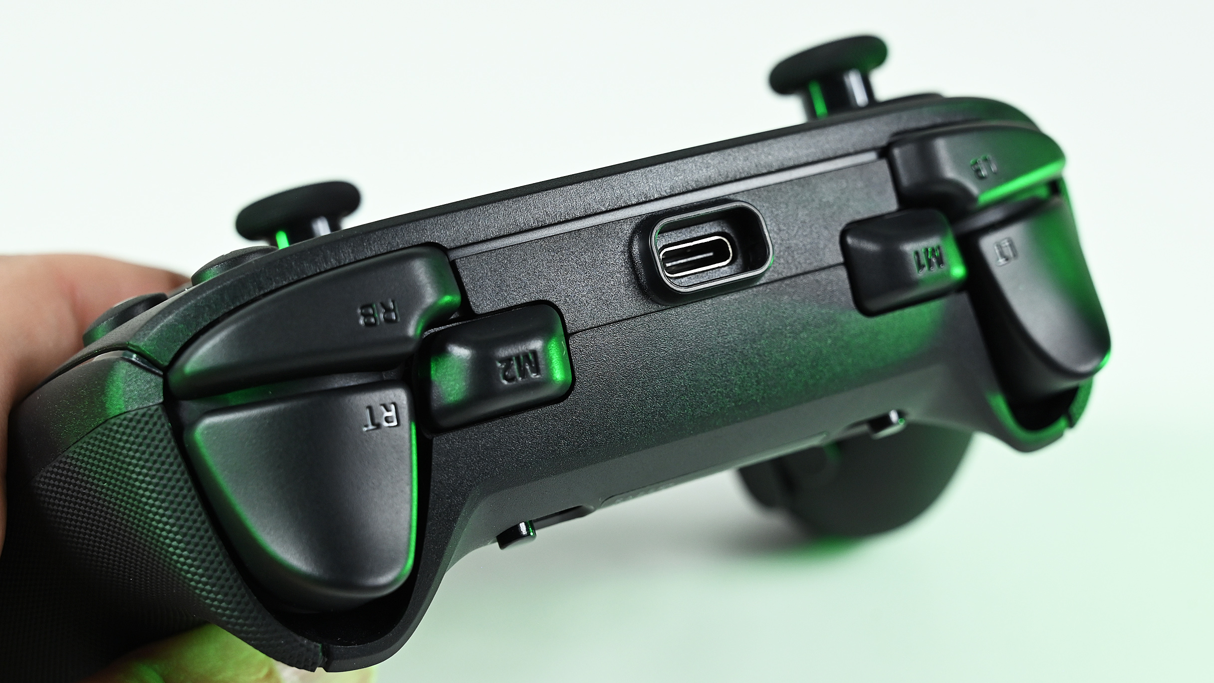 Close-up of the controller's top edge, highlighting the recessed USB-C connection port, bumper buttons, and remappable M1 and M2 buttons.