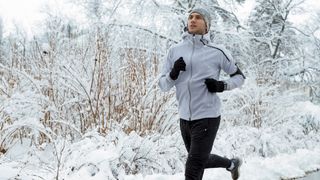 winter trail running gear: man running with hat