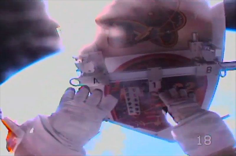 Astronaut Drew Morgan jettisons the debris shield from the Alpha Magnetic Spectrometer (AMS) during the first in a series of at least four spacewalks to repair the cosmic ray detector outside of the International Space Station on Friday, Nov. 15, 2019.