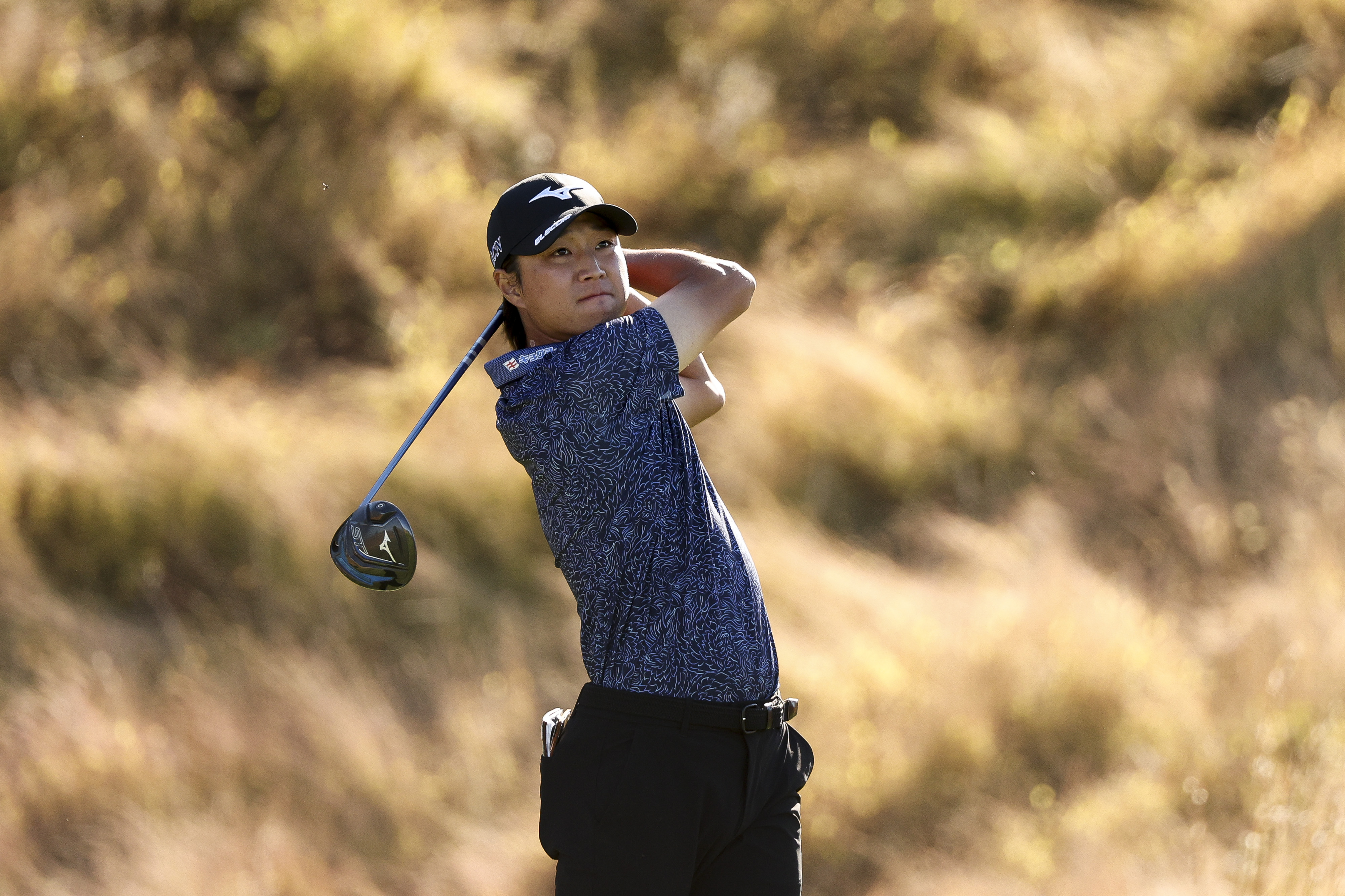 Kensei Hirata holds his finish on a drive