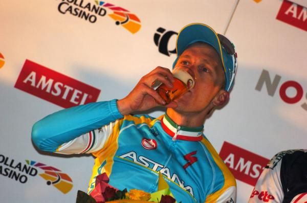 Cheers: Enrico Gasparotto (Astana Pro Team) enjoys a well-deserved beer on the Amstel podium