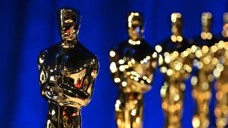 Oscar awards in front of a blue background