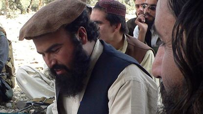 In this photograph taken on October 4, 2009 shows new Pakistani Taliban chief Hakimullah Mehsud (L) sits with his commander Wali-ur Rehman (R) during his meeting with local media representati