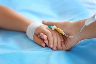 A child in a hospital bed.