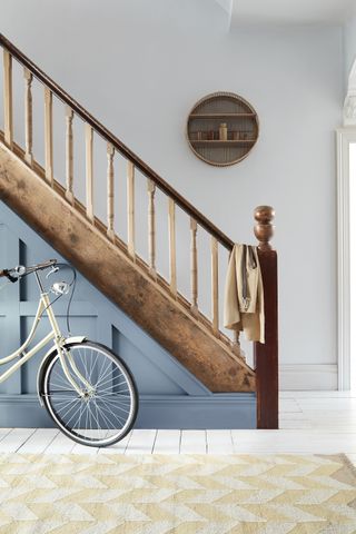 wooden staircase with blue paneling by Little Greene