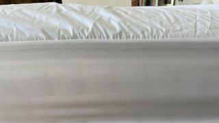 The side profile of the TheraPur ActiGel Cool Mattress Topper with the topper over it