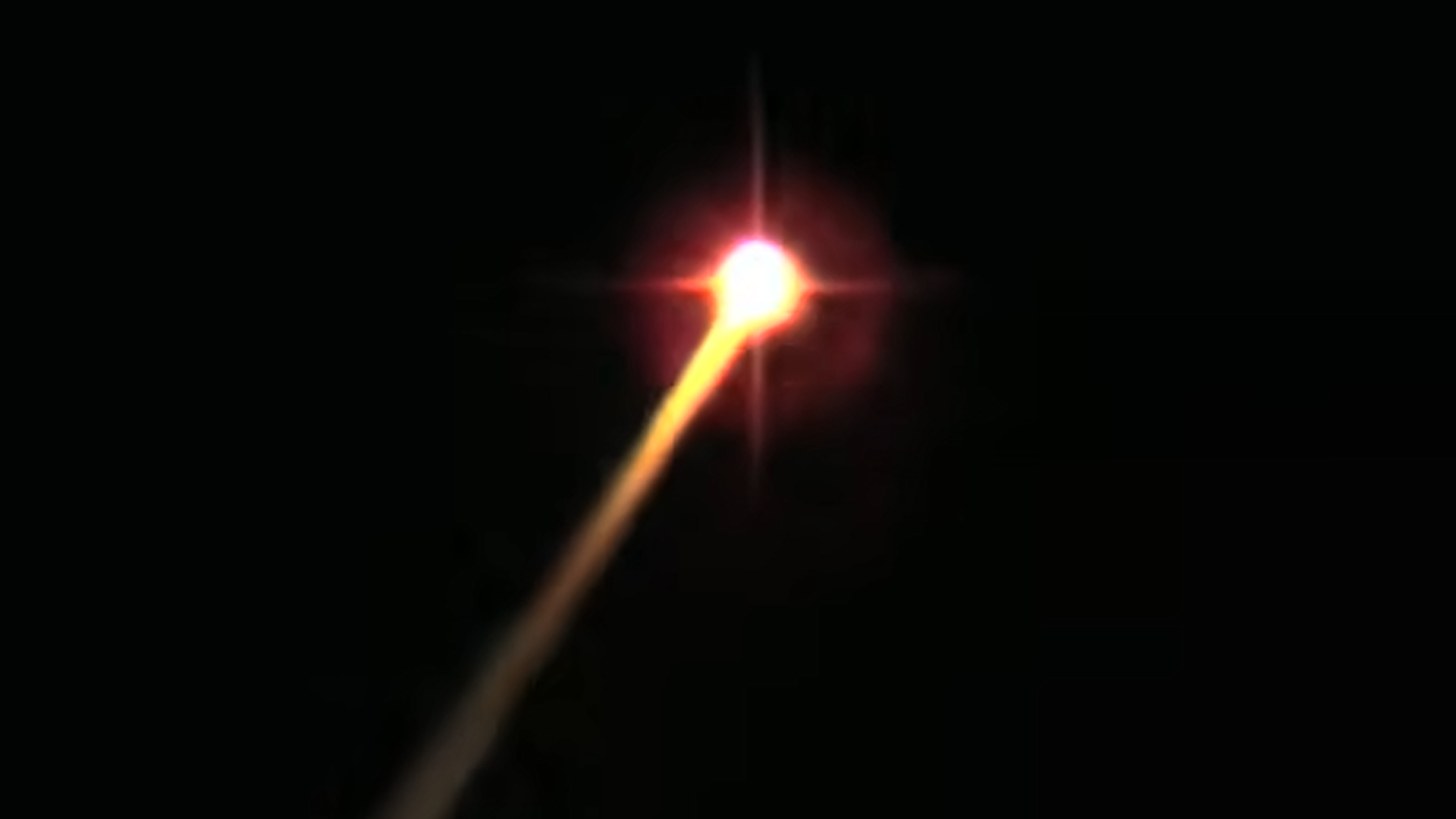 a bright fiery streak on a black background