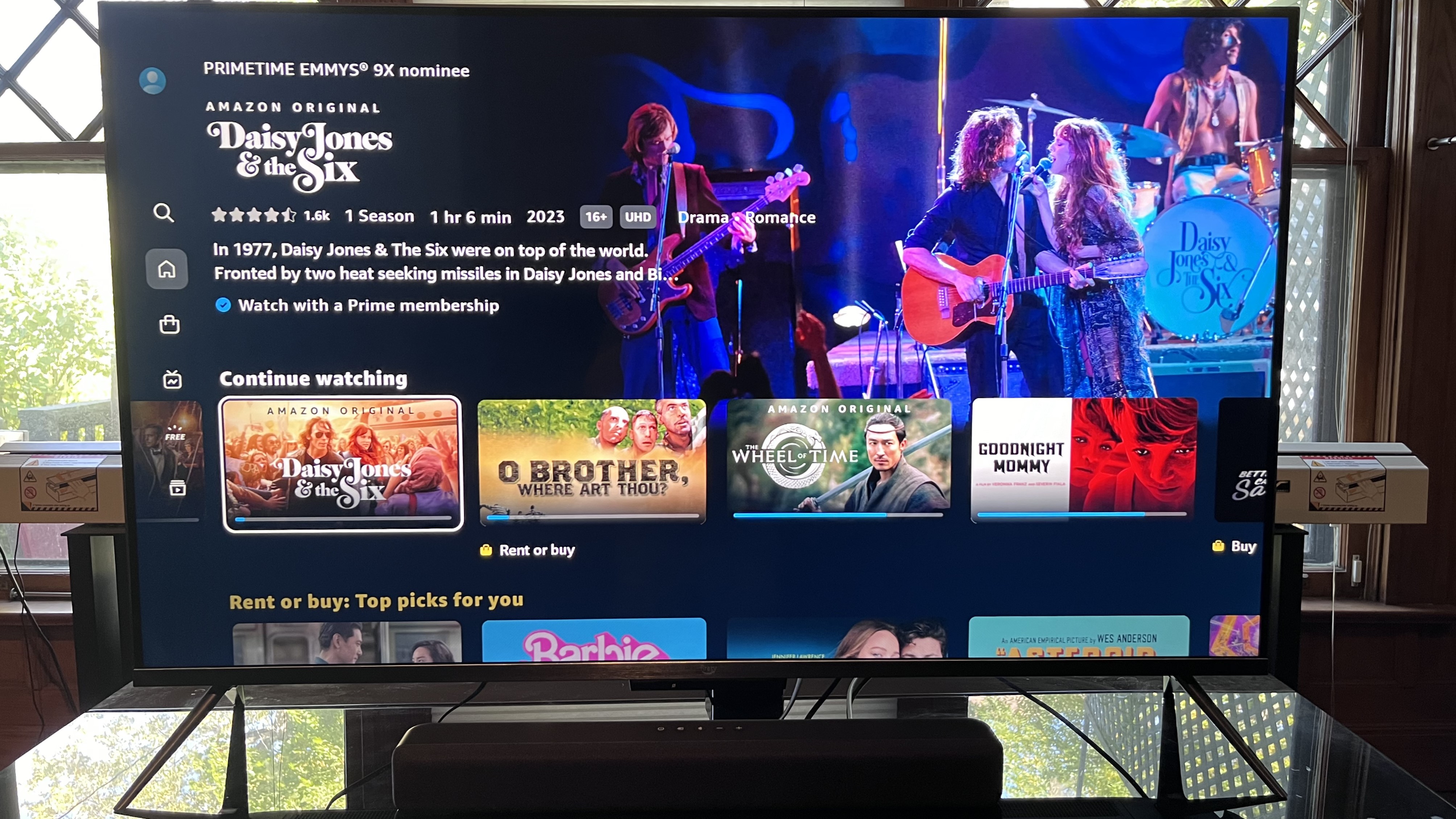 Amazon Fire TV soundbar on TV stand with Fire TV in background