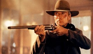 Unforgiven Clint Eastwood points his shotgun menacingly