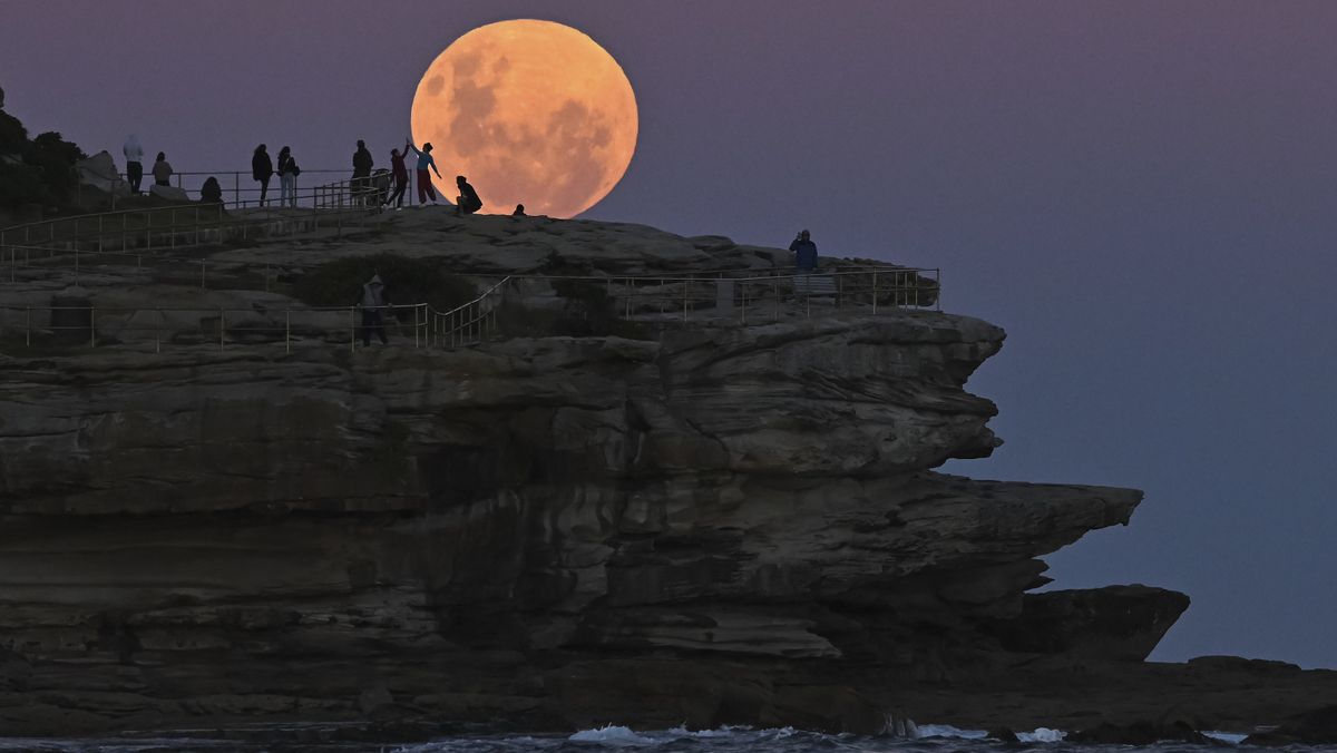 Spectators watch the total lunar eclipse of May 26, 2021, from Bondi Beach in Australia.