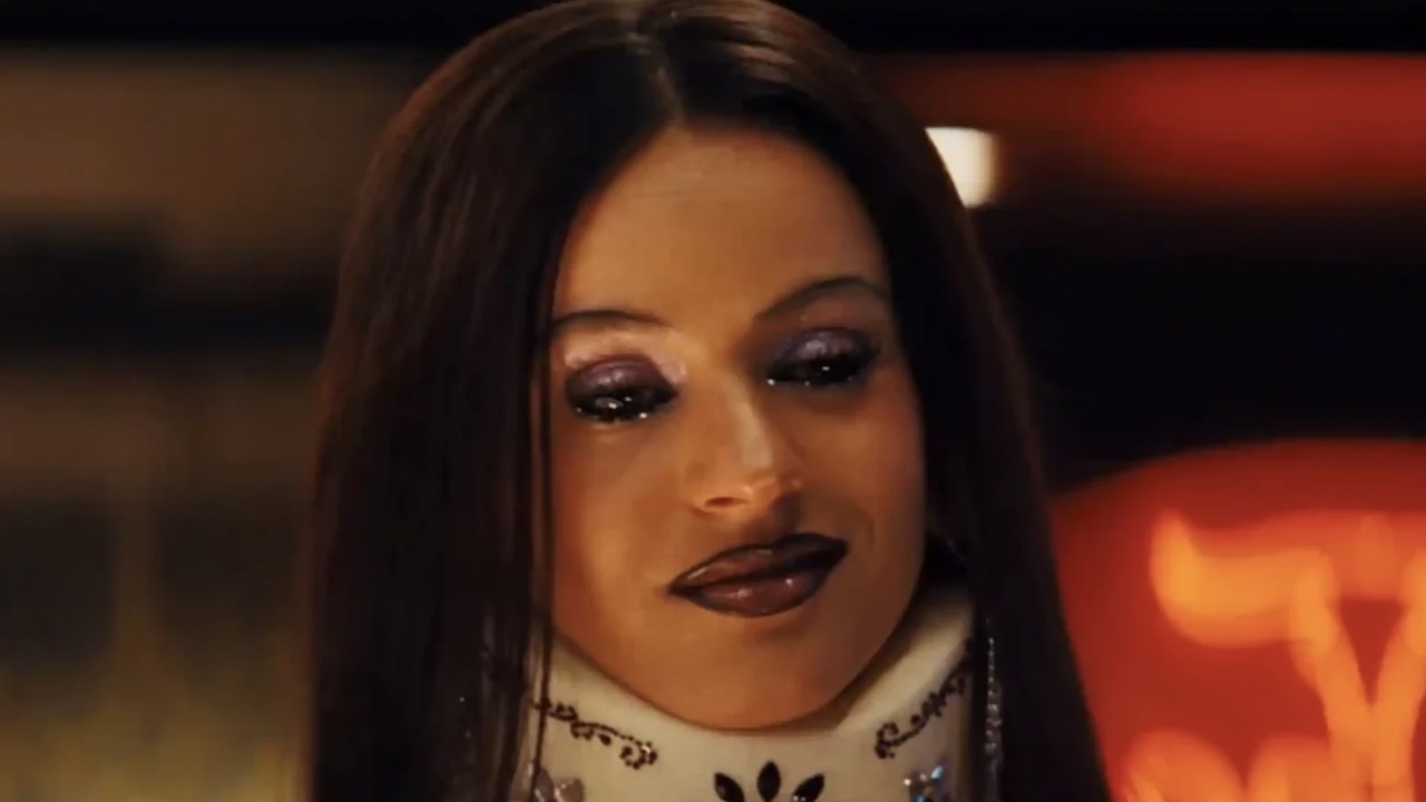 Magick smiling in her neck brace talking to Maddy.