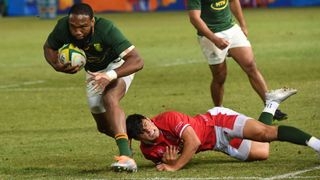 Lukhanyo Am of the Springboks takes on Louis Rees-Zammit of Wales during the first test match of the 2022 Castle Lager Incoming Series between South Africa and Wales at Loftus Versfeld