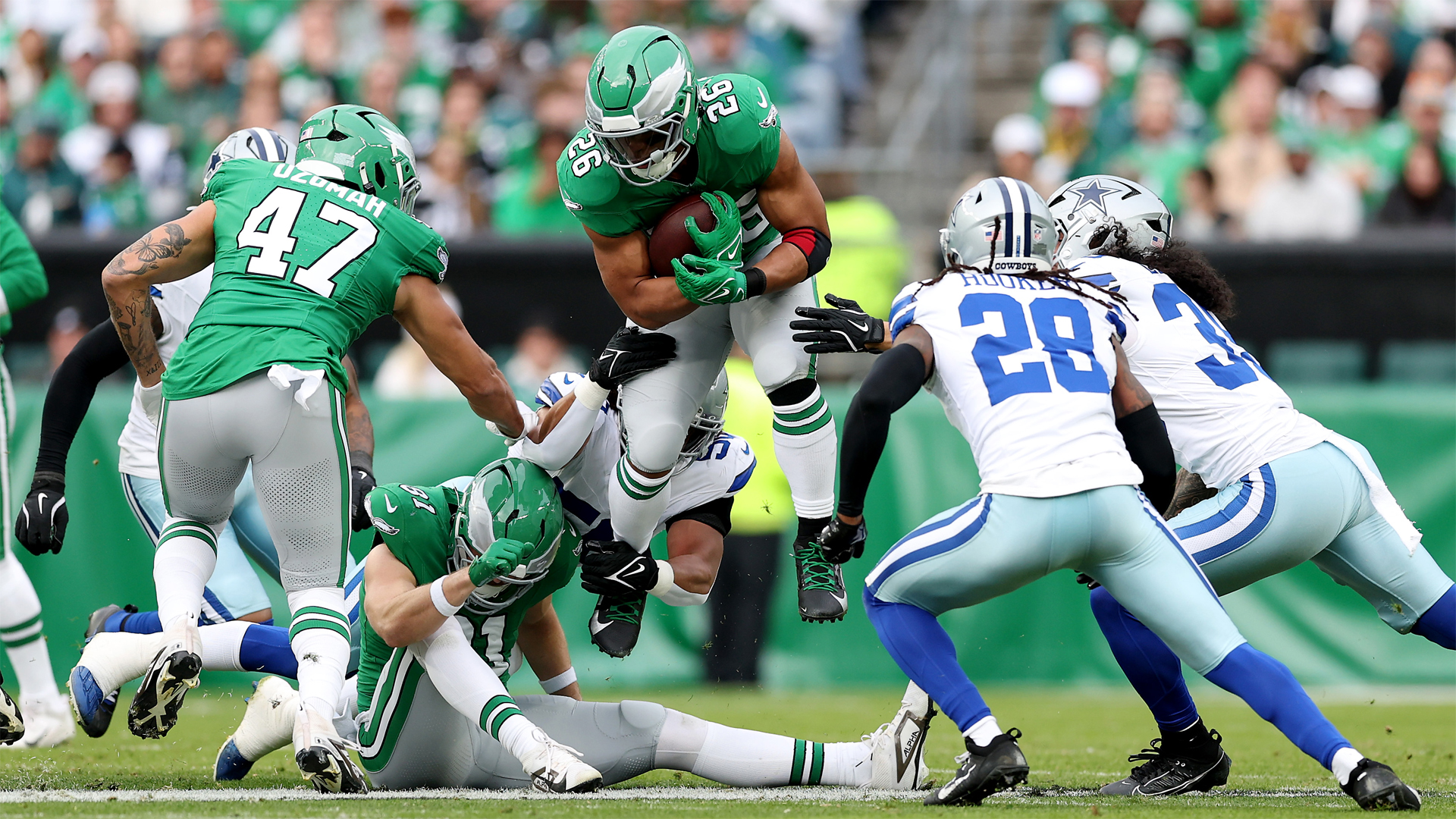 Saquon Barkley of the Philadelphia Eagles carries the ball against the Dallas Cowboys during a December 2024 NFL match.
