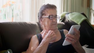An older person using their smartphone.