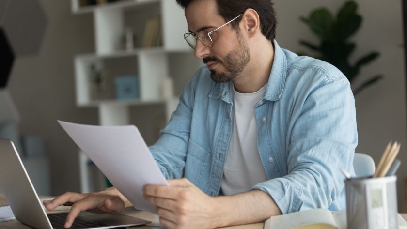 A man filing his taxes electronically on a laptop