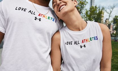 Models wearing a t-shirt with the slogan 'love all athletes', part of the Under Armour Pride Collection