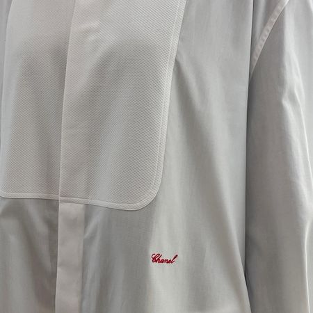 A close-up photo of Chanel's S/S 26 tuxedo shirt. 
