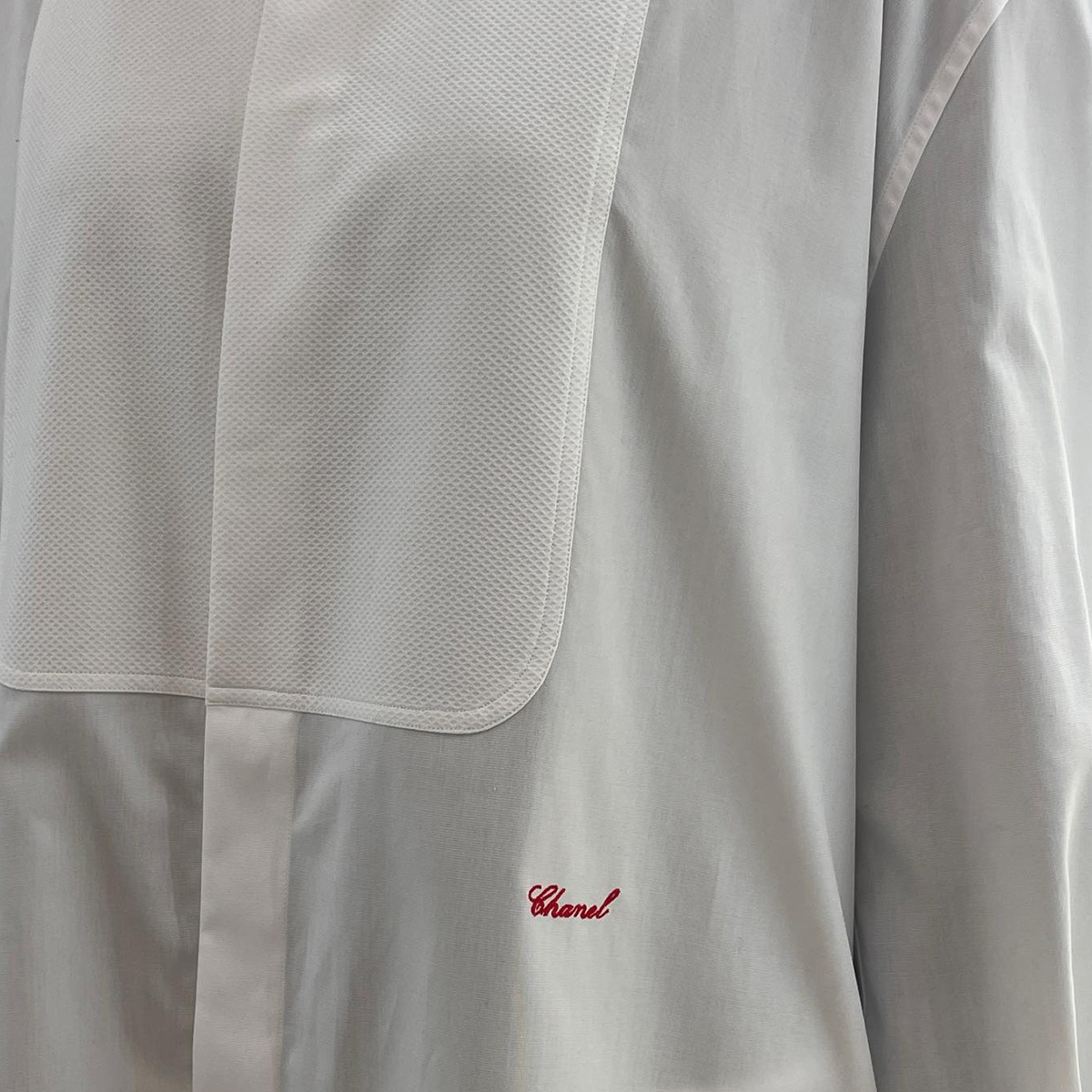 A close-up photo of Chanel's S/S 26 tuxedo shirt. 