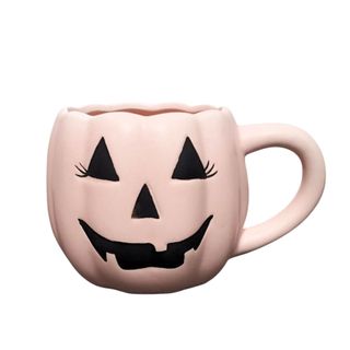 A pink pumpkin face and shape mug